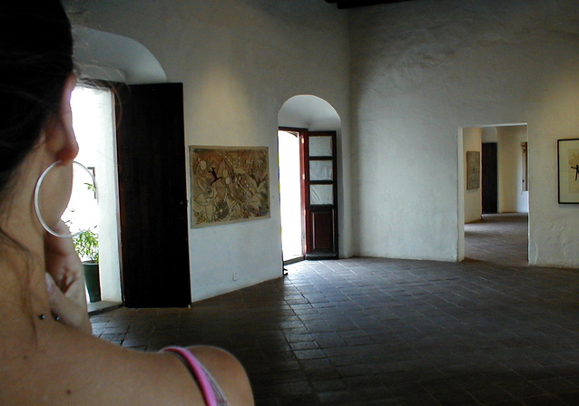 Žena stojí v dome s viacerými otvorenými a zatvorenými dverami.jpg